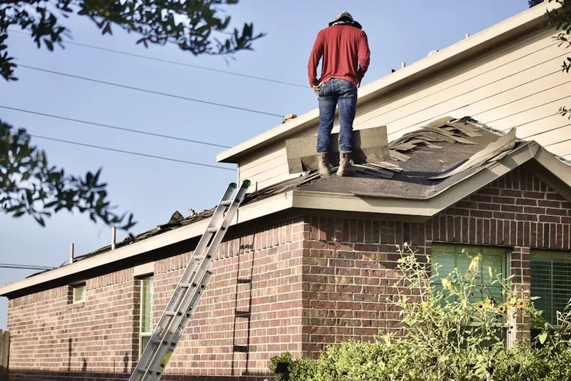 Professional roofer working on a residential roof in Naples